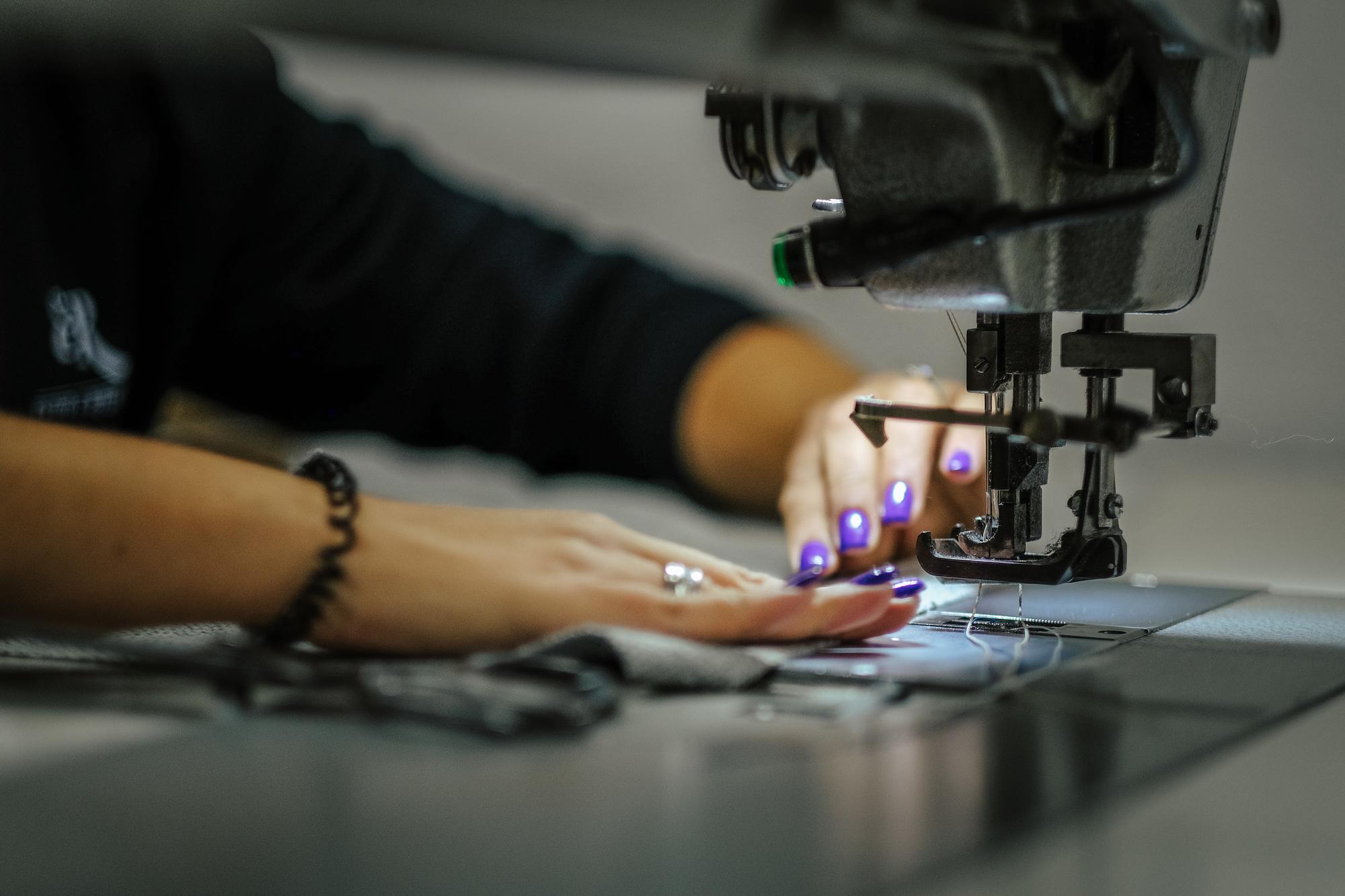Studio workspace with embroidery machines and samples