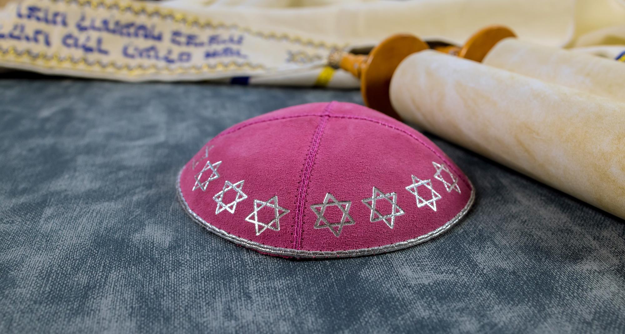 Hand-finished crest embroidered on wool